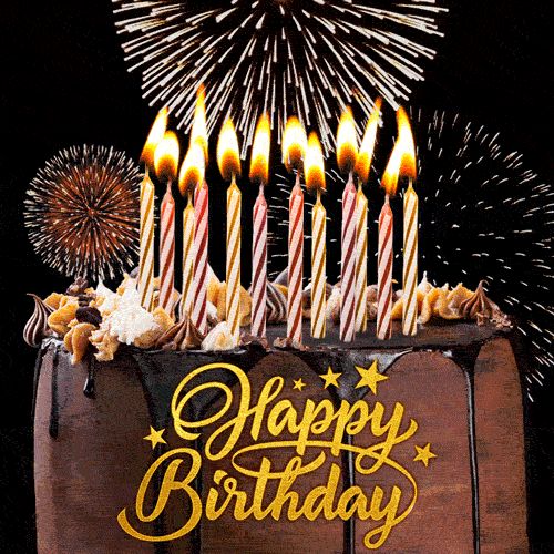 Dark chocolate birthday cake with candles, elegant golden lettering and bursts of fireworks on the black background.